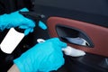 Car detailing series.Serviceman's Hand Cleaning Car Interior With Spray Can And Cloth,Selective focus Royalty Free Stock Photo