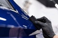 Car detailing studio worker applying ceramic coating on car Royalty Free Stock Photo