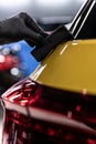 Car detailing studio worker applying ceramic coating on car Royalty Free Stock Photo