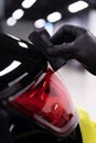 Car detailing studio worker applying ceramic coating Royalty Free Stock Photo