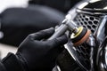 Car detailing technician polishing chrome shine decor on car Royalty Free Stock Photo