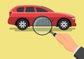 Car diagnostic concept. Hand with magnifying glass inspecting a car