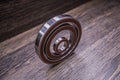 Car differential bearings on wooden background