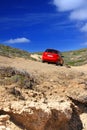 The car on a dirt road on a mountain slope. Greece Royalty Free Stock Photo