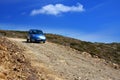The car on a dirt road on a mountain slope. Greece Royalty Free Stock Photo