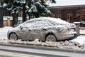 Car in dirty snow on side of the road