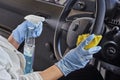 Car disinfecting service. Cleansing car interior and spraying with disinfection liquid