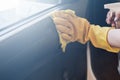 Car disinfecting service. Woman disinfecting inside car door handle