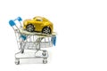 Car and dollar in a shopping trolley on a white background. Car as a gift. Buy a car. Copy of space