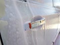 Car door handle coated with active foam. Royalty Free Stock Photo