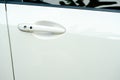 Car door handle on driver's door of modern white car Royalty Free Stock Photo