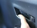Car door handle open with hand. Car interior details.