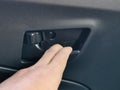 Car door handle open with hand. Car interior details.