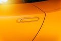 Car door handle of an orange modern car