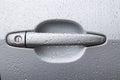 Car door handle in raindrops close up Royalty Free Stock Photo