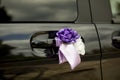 Car door handles wedding decoration. Purple bow on the car Royalty Free Stock Photo