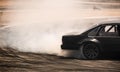 Car drifting, diffusion race drift car with lots of smoke from burning tires on speed track Royalty Free Stock Photo