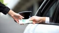 Car driver giving euro banknote female worker, parking payment, ticket purchase