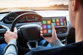 Car driver use smart phone with smart car app and use connection with car infotainment system Royalty Free Stock Photo