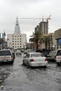 A car drives carefully through the built-up rain water in the streets of Riyadh, Saudi Arabia