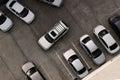 A car drives into an empty parking space among various other cars. View from above. Concept. Copy space