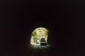 Car drives through the Highway Urban Tunnel. View from badly lit tunnel from a fast moving car on a sunny day. Motion Blur Royalty Free Stock Photo