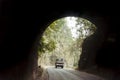 Car drives through the Highway Urban Tunnel. View from badly lit tunnel from a fast moving car on a sunny day. Motion Blur Royalty Free Stock Photo