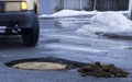 The car drives past the pothole with puddles on the road Royalty Free Stock Photo