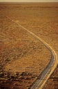 Car driving along desert road outback Australia