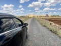 Car driving on asphalt road in ountryside under beautiful blue sky Royalty Free Stock Photo
