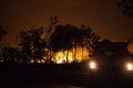 car driving away from a bushfire, forest is really bright because of the fire, litchfield national park, australia Royalty Free Stock Photo