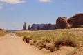 Car driving away in Monument Valley