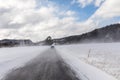 Car driving in winter blizzard on snowy road in Norway Royalty Free Stock Photo