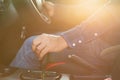 Car driving concept : Driver hand on automatic gear inside the modern car. Car interior with morning golden sun light flare effect