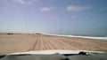 Car driving at dirt road in desert. Sand drive at the beach. Coast of sea. Royalty Free Stock Photo