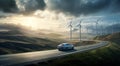 Car driving down road with windmills in background Royalty Free Stock Photo