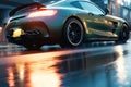 a car driving down a wet street at night with its lights on and a reflection on the wet ground in front of the car is a building Royalty Free Stock Photo