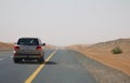 Car driving on an empty road in the deserts of Dubai, UAE Royalty Free Stock Photo