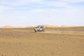 Car driving in the Erg Chebbi desert in Morocco Royalty Free Stock Photo