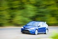 Car driving fast on country road