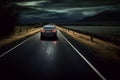 Car driving fast on the countryside road at dusk. Autumn rural landscape and sky with clouds Royalty Free Stock Photo