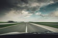 Car driving fast down on the highway before the rain Royalty Free Stock Photo