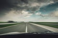 Car driving fast down on the highway before the rain Royalty Free Stock Photo