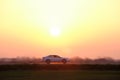 Car driving fast on intercity road at sunset. Highway traffic in evening