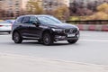 Car driving fast motion on the highway, front side view. Brown Volvo XC60 Second generation moving on the street