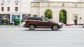 Car driving fast motion on the highway, side view. Brown Volvo XC60 first generation moving on the street