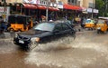 Car driving on a flooded road during a flood caused by heavy rain Royalty Free Stock Photo