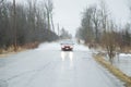 Car driving through flooded roadway