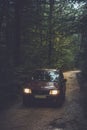 Car driving into a forest. Royalty Free Stock Photo