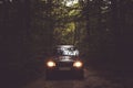 Car driving into a forest. Royalty Free Stock Photo